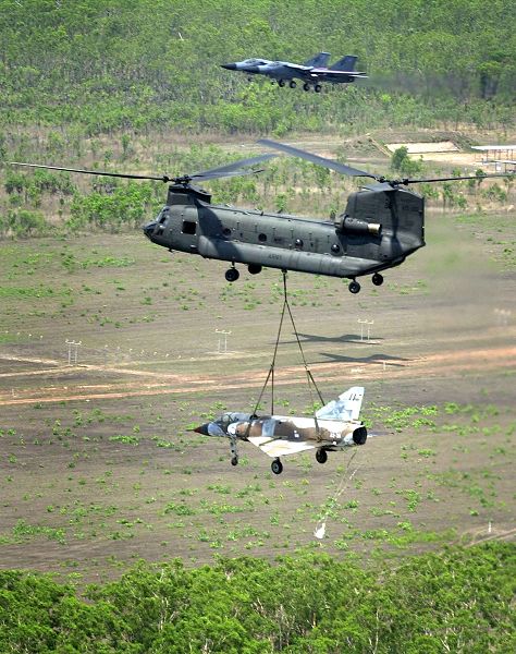 Australian Chinook slings an old two seat Mirage fighter down to Tyndal Air Force base for restoration.