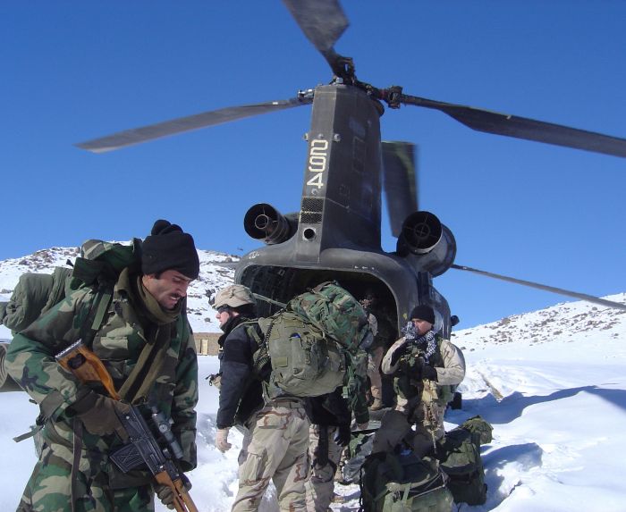 A scout team from 2nd Battalion, 35th Infantry Regiment, 25th Infantry Division, exits a CH-47D Chinook in Garzak. The Soldiers are there to train local Afghan police.