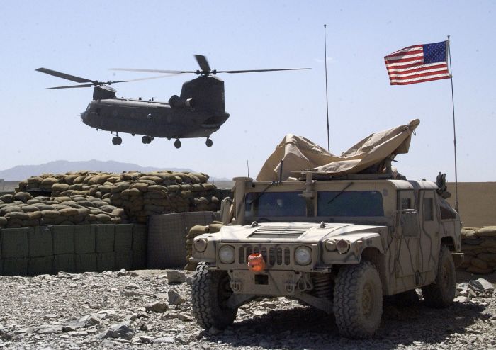 7 April 2004: Soldiers aboard a CH-47D Chinook helicopter land to refuel on a firebase at Orgun-E, Afghanistan. Army aviation assets are playing a critical role in helping U.S. Soldiers and Coalition forces destroy remnants of the Taliban regime and the Al Qaeda terrorist network during Operation Enduring Freedom in Afghanistan.