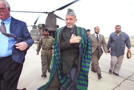 Afghan interim leader Hamid Karzai walks off a U.S. Army Chinook helicopter.