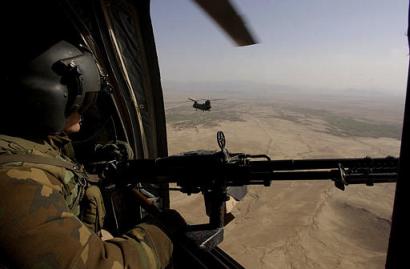 A door gunner on a Chinook looks out over Helmand province, Afghanistan.