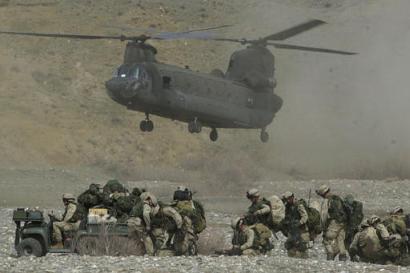 A US Army Chinook CH-47D helicopter lands to pick-up soldiers.
