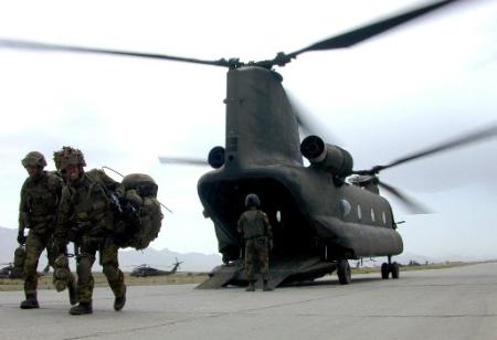 Canadian troops disembark from an American CH-47D Chinook helicopter.