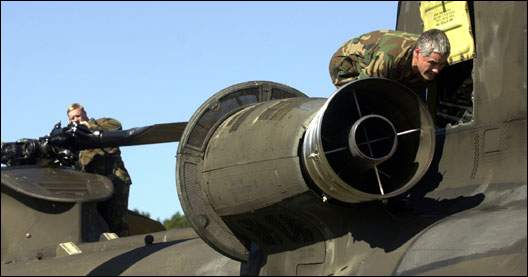 U.S. Army Specialist Daniel Stewart and Chief Warrant Officer David King check for additional problems on their flying machine.