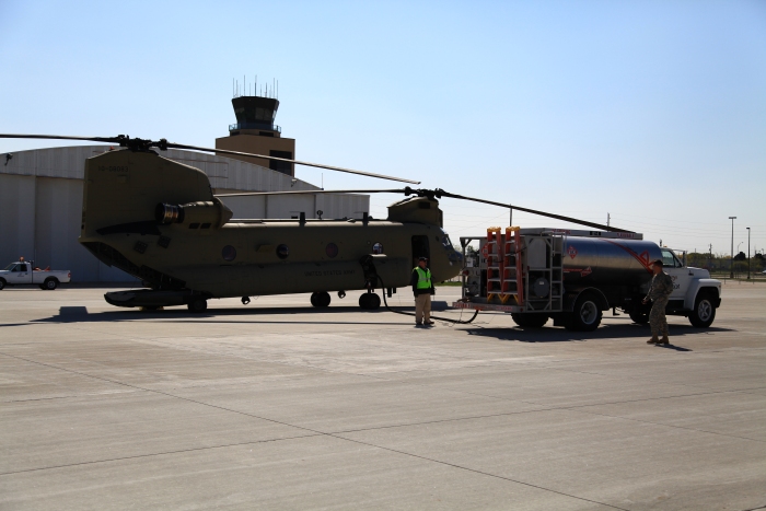 11 April 2012: Sortie 1 stopped at Sioux City, Iowa, for fuel and food. LTC Killen walks past Chinook helicopter 10-08083 as the aircraft receives approximately 10,000 pounds (1,500 gallons) of fuel.