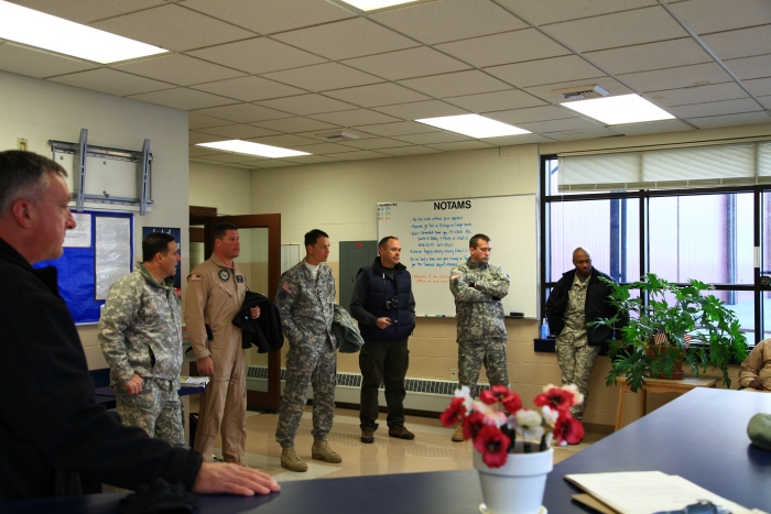 16 April 2012: Pilots discuss the weather situation prior to the flight into Canada in the Operations section of the Army National Guard's facility at Helena.