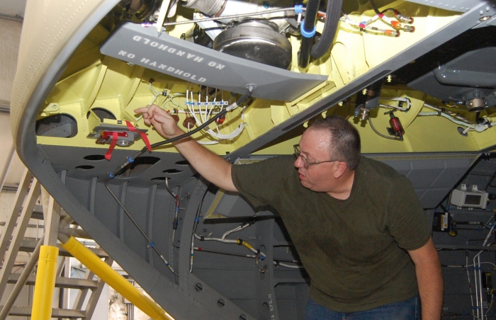 Karl Meixner, Defense Contract Management Agency Quality Assurance Specialist, performs a safety of flight inspection on the rear section of an CH-47F Chinook helicopter at Boeings Ridley Park, Pennsylvania production plant.