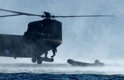 Greek special forces jump out of a Chinook helicopter as they conduct an exercise at the military camp of Nea Peramos, 20 miles west of Athens on Monday. Greece's elite special forces held land and sea exercises as U.S. and Greek troops plan to stage joint exercises in Greece beginning in March as part of security preparations for the Athens Olympic Games. Defense Minister Yiannos Papantoniou, attending the exhibition, told reporters that NATO countries are involved in the security planning of the August 13-29 Games, and will be ready to intervene if a crisis erupts.