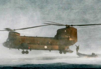 Greek Army special forces jump from a Chinook CH-47 helicopter during an Olympic security exercise at the islet of Nea Platia, near Athens, as the sun was setting. Massive Olympic security measures began going into effect on Thursday, 1 July 2004.