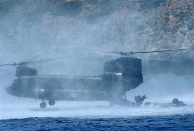 Members of an elite Greek Navy unit jump from a Chinook helicopter to a raft in the Mirtoo sea during a military exercise. The one-day "Dolphin 05" exercise was conducted by Navy, Army and Airforce units at Saronic Gulf and Mirtoo Sea south of Athens.