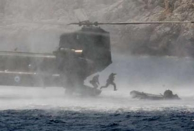 Members of an elite Greek Navy unit jump from a Chinook helicopter to a raft in the Mirtoo sea during a military exercise. The one-day "Dolphin 05" exercise was conducted by Navy, Army and Airforce units at Saronic Gulf and Mirtoo Sea south of Athens.