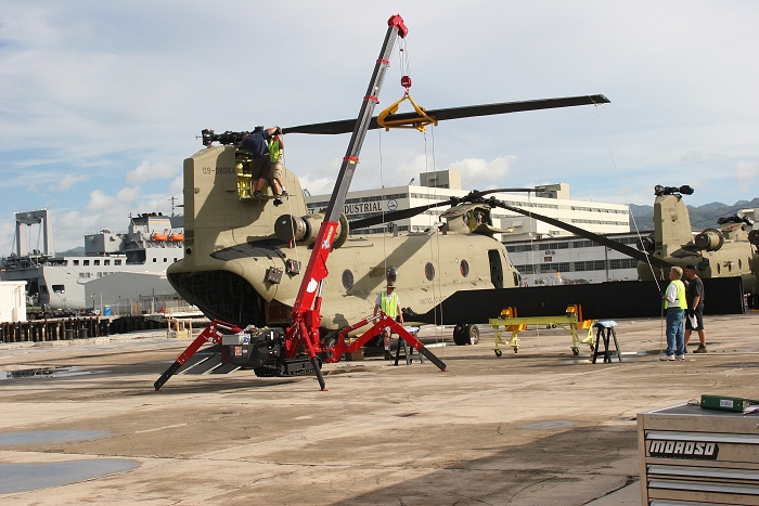19 November 2010: A close-up view of the reassembly of CH-47F Chinook helicopter 09-08064. What's fascinating is the lifting device used to install the rotors lades. It is known as a Spyder Crane. It manuevers like a spider on tracks and is remote controlled.