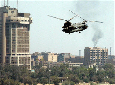 A U.S. Army CH-47 Chinook helicopter flies over Baghdad. Four people have been arrested in Iraq in connection with the beheading of US businessman Nicholas Berg, a senior Iraqi source said, as a funeral service was held here for slain Governing Council president Ezzedine Salim.