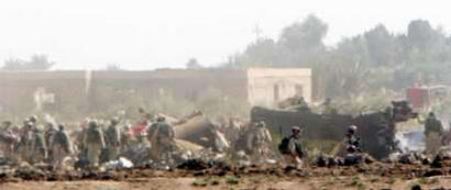 U.S. Army troops search the site where a Chinook helicopter crashed into a field near the restive town of Falluja on Sunday, 2 November 2003. Guerrillas shot down the U.S. Chinook helicopter as it flew toward Baghdad airport, killing 15 soldiers in the bloodiest single attack on occupying troops since Saddam Hussein was overthrown.