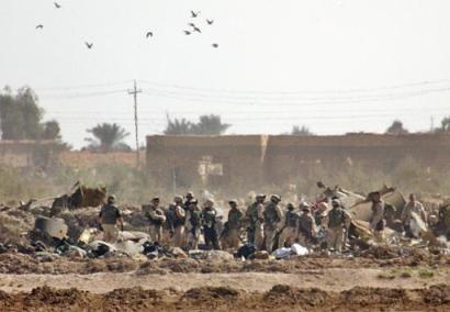 U.S. soldiers search through the rubble after a U.S. Chinook helicopter believed carrying dozens of soldiers to leaves abroad was struck by a missile and crashed west of Baghdad, near Fallujah on Sunday, 2 November 2003, killing 15 soldiers and wounding 26 others, the U.S. command and witnesses reported.