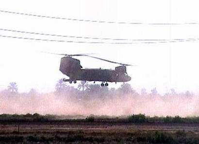 A Chinook helicopter hovers over the scene where guerrillas shot down another U.S. Chinook helicopter as it flew towards Baghdad airport on 2 November 2003. 15 soldiers were killed in the crash and 26 wounded, near the village of Baisa, south of the flashpoint town of Falluja, a stronghold of anti-U.S. resistance 50 km (32 miles) west of Baghdad.