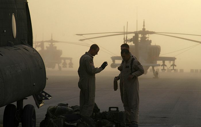 CH-47D Chinook helicopter crewmembers of the 101st Airborne Division converse on the flight line.