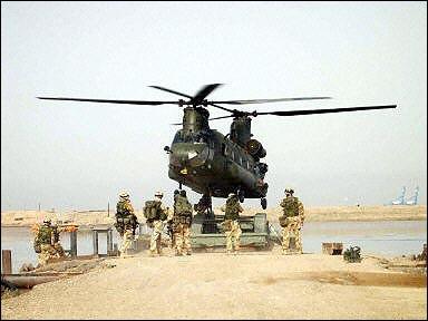 A Chinook helicopter comes in low as it works to lower a mobile bridge into exactly the right place on the banks of the Shat Al Basra.