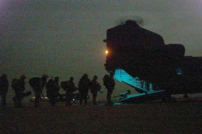 British Royal Marines from C-Company 40 Commando board chinook helicopters from 18 Squadron Royal Air Force.