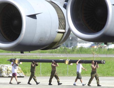 Loading a U.S. Army MH-47E Chinook helicopter aboard a U.S. Air Force C-17 transport aircraft for the return trip home.