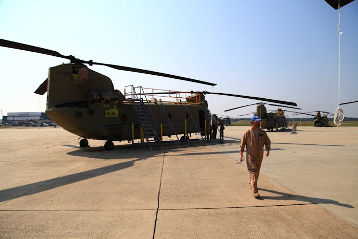 11 September 2013: Tim Coffman, Flight Engineer, walks away from CH-47F Chinook helicopter 12-08103 and a hot and humid day.