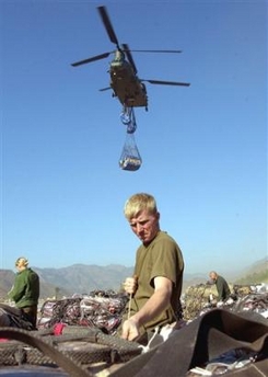 16 November 2005: British soldiers wrap up tents, food and other supplies to earthquake victims before airlift by British CH-47 Chinook helicopters at an airport in Muzaffarabad, Pakistan, on Wednesday. Two British military helicopters on Wednesday joined an increasingly urgent push to send supplies to survivors of last month's earthquake that killed more than 86,000 people and devastated large parts of mountainous northern Pakistan.