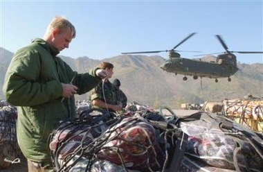 16 November 2005: British soldiers wrap up tents, food and other supplies to earthquake victims before airlift by British CH-47 Chinook helicopters at an airport in Muzaffarabad, Pakistan, on Wednesday. Two British military helicopters on Wednesday joined an increasingly urgent push to send supplies to survivors of last month's earthquake that killed more than 86,000 people and devastated large parts of mountainous northern Pakistan.