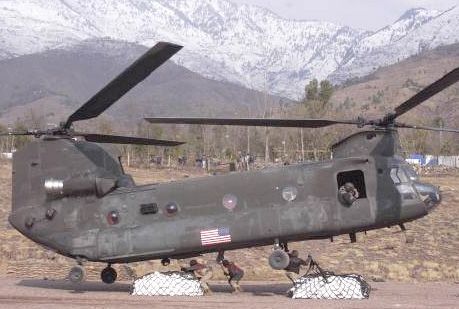 A U.S. Army CH-47D Chinook helicopter externally loads humanitarian relief supplies in Muzaffarabad, Pakistan.