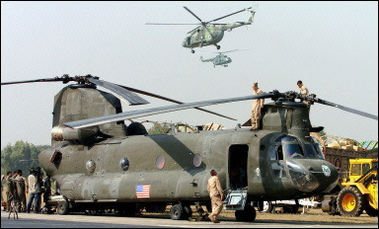 A US Chinook helicopter from "Big Windy" loaded with relief goods in Pakistan. The US military said its helicopters resumed aid deliveries to Pakistani quake victims but were avoiding an area where one of its Chinooks came under suspected rocket fire in Kashmir.