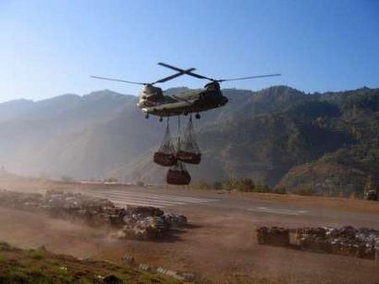 16 November 2005: A British Royal Air Force Chinook helicopter lifts aid supplies for Pakistani earthquake victims at an air strip near Muzaffarabad. The U.N. and British military launched an airlift on Wednesday to move hundreds of tonnes of food and shelter to earthquake survivors high in Pakistan's mountains to ensure they survive the winter.