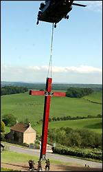 The cross was airlifted by an RAF Chinook helicopter into position outside the abbey on Monday.