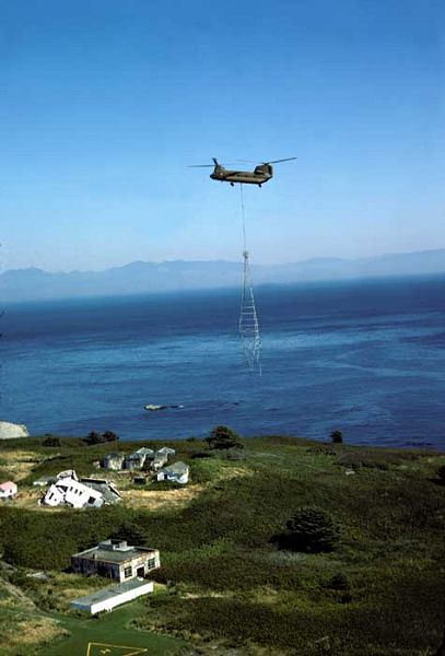 An A model Chinook supports the United States Coast Guard on Tatoosh Island in Washington State. As shown here, a CH-47A Chinook removes the tower from the island. Notice that the old meterological station is now demolished. September 1975.