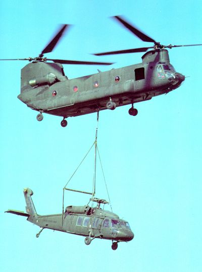 A UH-60 "Blackhawk" gets a lift from a CH-47D "Chinook".