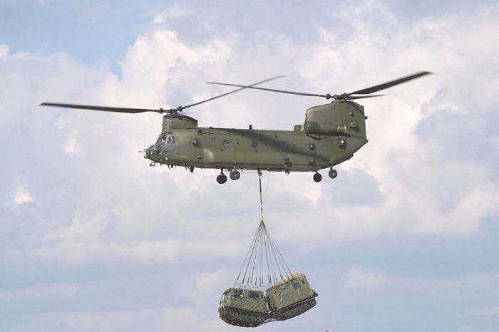 A Chinook lifts one of the Royal Marines' BV206 vehicles.