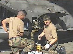 Flippers repair the landing gear on Chinook 85-24339.